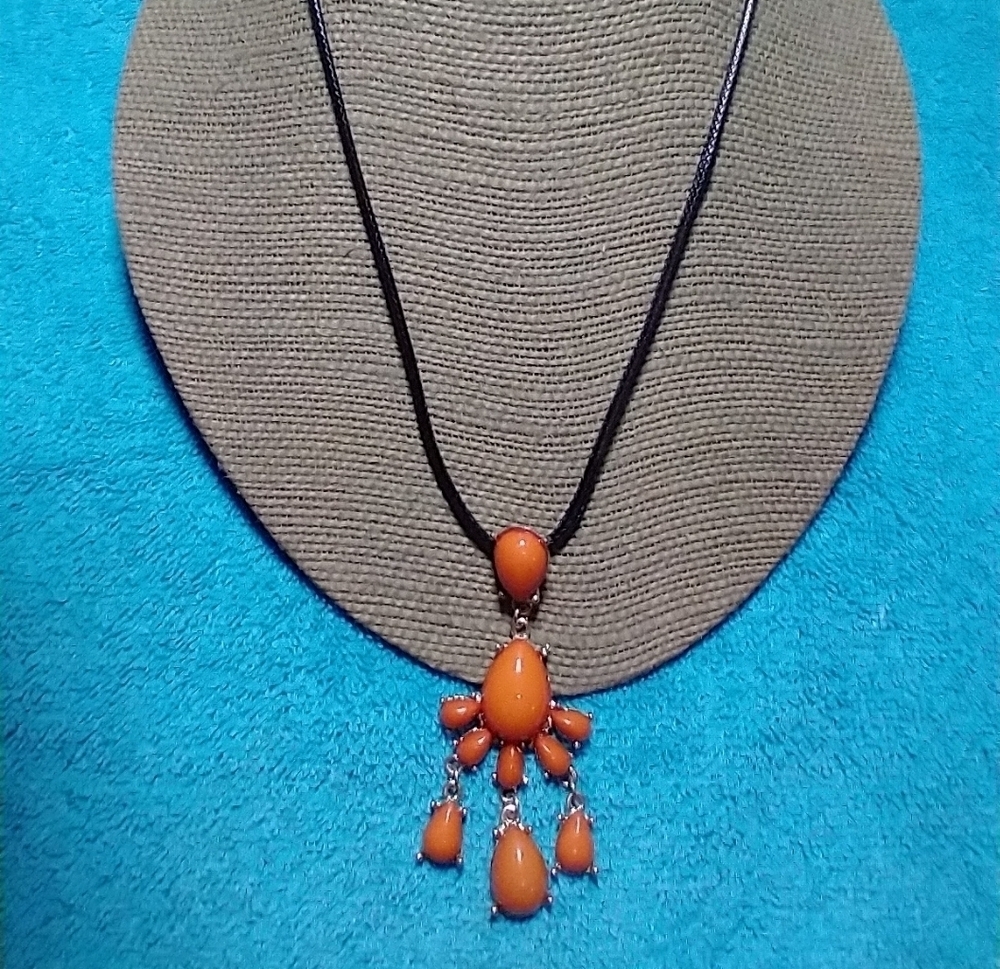 Goldtone orange abstract dangle necklace black cord